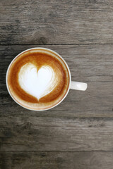 a cup of latte art coffee on wooden background            