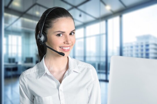 Call center female agent with headset at work in office, AI generated image