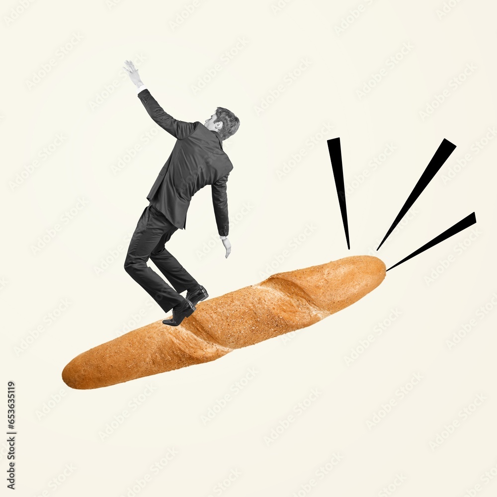 Wall mural Young businessman sliding on big baguette