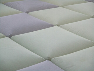 surface made up of square cushions that form a texture
