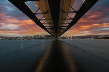 Fototapeta na wymiar New Halic Metro Bridge at summer night blue sky and city lights in Istanbul, Turkey