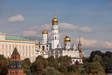 Fototapeta na wymiar View of Moscow on an autumn day. Kremlin towers. The Grand Kremlin Palace, the Bell Tower of Ivan the Great and the Assumption Cathedral. A popular tourist attraction.MOSCOW, RUSSIA - SEPTEMBER 2023.