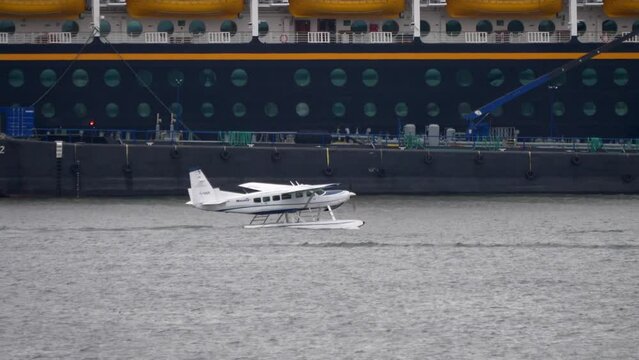 Cessna Caravan C208 Seaplane in the Harbor with Ships in Background