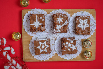Chocolate brownies with icing sugar decorations together with Christmas decorations. Christmas...