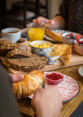 Croissant being sliced open during breakfast at a bakery café