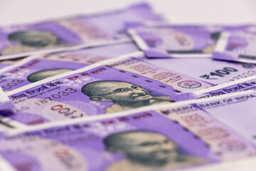 100 rupee notes with white background - earning concept..