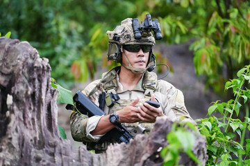 Military army soldiers tactical team, commando group moving cautiously in forest area, kneeling and...