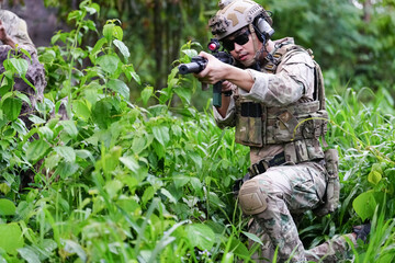 Military army soldiers tactical team, commando group moving cautiously in forest area, kneeling and...