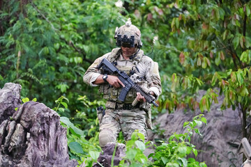 Military army soldiers tactical team, commando group moving cautiously in forest area, kneeling and...