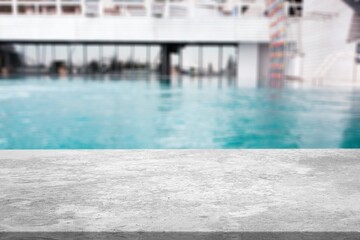 Empty blank table top on swimming pool background