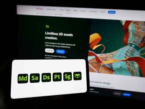 Stuttgart, Germany - 09-23-2023: Person holding cellphone with logo of software product Adobe Substance 3D on screen in front of business webpage. Focus on phone display.