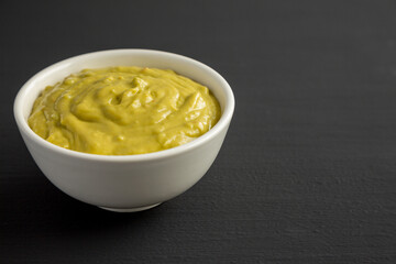 Homemade Avocado Guacamole in a Bowl, side view. Copy space.