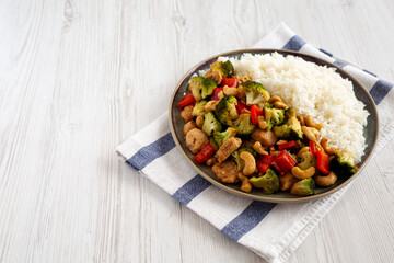 Homemade Cashew Chicken Stir-Fry on a Plate, side view. Copy space.