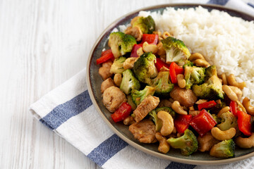 Homemade Cashew Chicken Stir-Fry on a Plate, side view. Copy space.