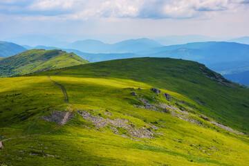 Fototapeta na wymiar carpathian landscape in summer. rolling hills of watershed ridge in dappled light. travel ukraine