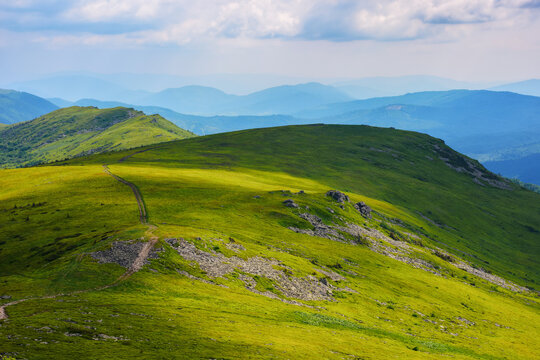 carpathian landscape in summer. rolling hills of watershed ridge in dappled light. travel ukraine