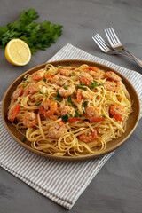 Baked Shrimp Scampi Linguine Pasta with Parsley on a Plate, side view.