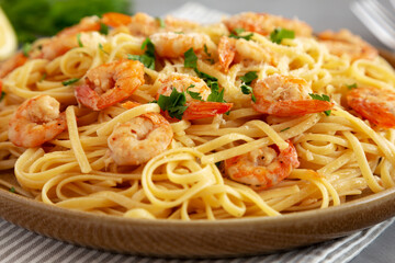 Baked Shrimp Scampi Linguine Pasta with Parsley on a Plate, side view. Close-up.