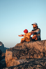 Family father and child outdoor practicing yoga in mountains healthy lifestyle vacations parent and kid training together harmony with nature meditation