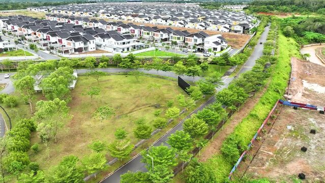 Aerial view of new white terraced houses on back-to-back streets in the suburbs of Malacca, northern Malaysia, captured in 4K drone footage.