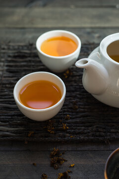 Table top photography of far-eastern or asian tea ritual. Herbal tea served in japanese cups on wooden rustic background.