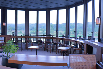  Curved glass room, building design, curved wooden table, green natural view.