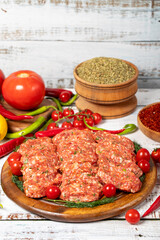 Meatballs on wood background. Raw beef meatballs with herbs and spices