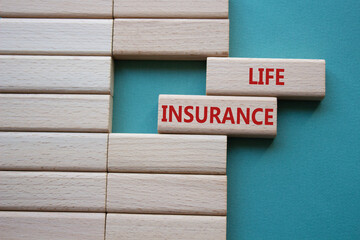 Life insurance symbol. Concept word Life insurance on wooden blocks. Beautiful grey green...