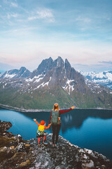 Family hiking in Norway mother with child on mountain top travel together active healthy lifestyle...