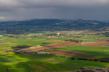 Fototapeta na wymiar View of Kfar Yehoshua from Muhraqa viewpoint on Mount Carmel in Israel. Kfar Yehoshua is a moshav, farming community that is laid out in a circular shape. 