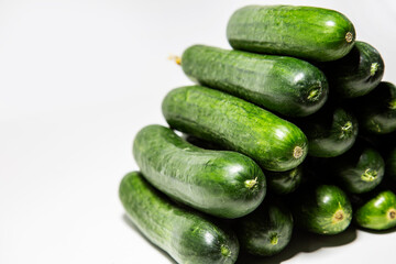 pyramid bunch of fresh green cucumbers front view on white background isolated copy space