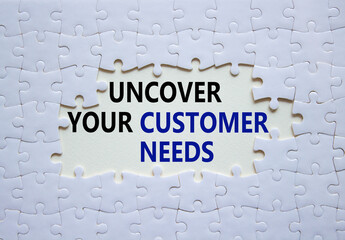 Customer Needs symbol. White puzzle with words Uncover your Customer Needs. Beautiful white...
