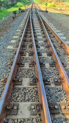 Fototapeta premium Transportation background of two track old rusty railway in urban area 