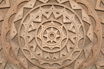 mandala texture made of cement. Background with brown mandala