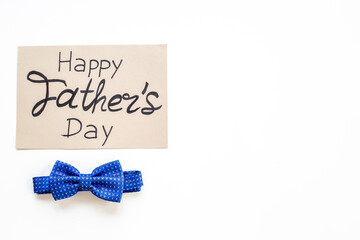 Happy Fathers day handmade postcard with blue bow tie, top view