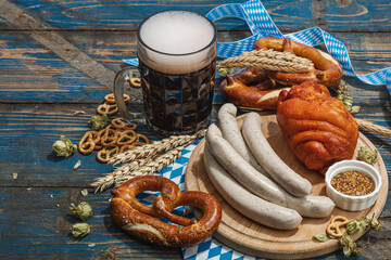 Traditional Oktoberfest set. Pretzels, beer, weisswurst, eisbein with mustard. German festival food