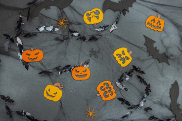 Funny Halloween background. Scary spider web, traditional fall pumpkins, bats and spiders