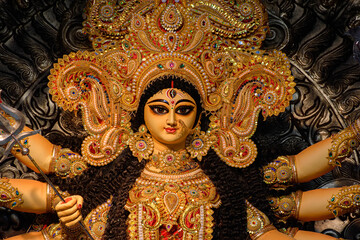 Idol of Goddess Devi Durga at a decorated puja pandal in Kolkata, West Bengal, India. Durga Puja is...