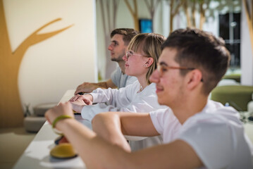 Obraz premium Students at a Quiz Competition with Hands on a Button