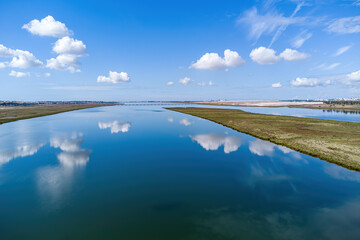 Aerial drone view of river Tinto mouth. Estuary of Rio Tinto in the marshes of Huelva with a beautiful reflection of the sky