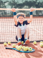 Positive kid tennis player having fun on court