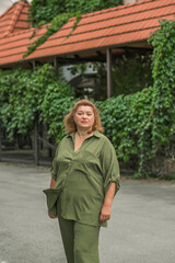 Plus size European or American mature woman at city, enjoy the life, walks around. Life of people xxl size, happy nice natural beauty lady. Concept of overweight