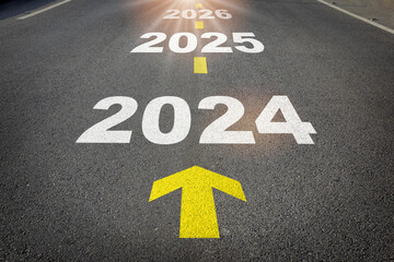 2024 to 2026 written on the road background with yellow arrow. Business planning recovery concept and new year beginning success idea - obrazy, fototapety, plakaty