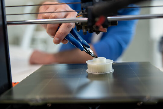 Designer working with 3D printer creative lab.