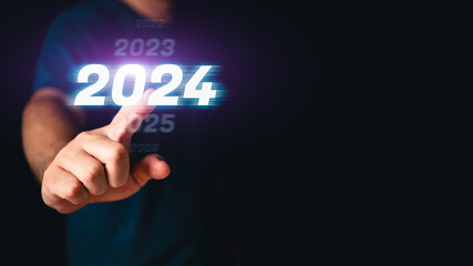 Man hand toching the 2024 abstract cyberpunk technology interface by poinitng finger on isolated black background with copy space. Happy New Year 2023 to 2024 concept. Innovation and hitech theme.