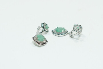 Natural gemstone on silver jewelry display on white background