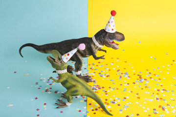 a pair of dinosaurs celebrating on a confetti carpet