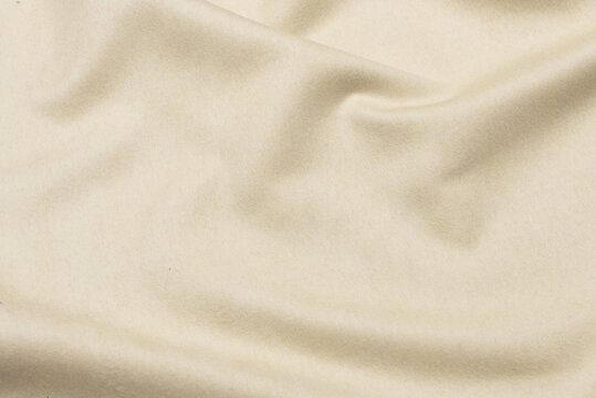 Close-up texture of natural gray or ivory or white color fabric. Fabric texture of natural silk satin or cotton textile material. Light canvas background.