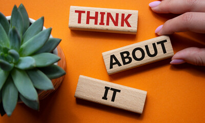 Think about it symbol. Wooden blocks with words Think about it. Beautiful orange background with...