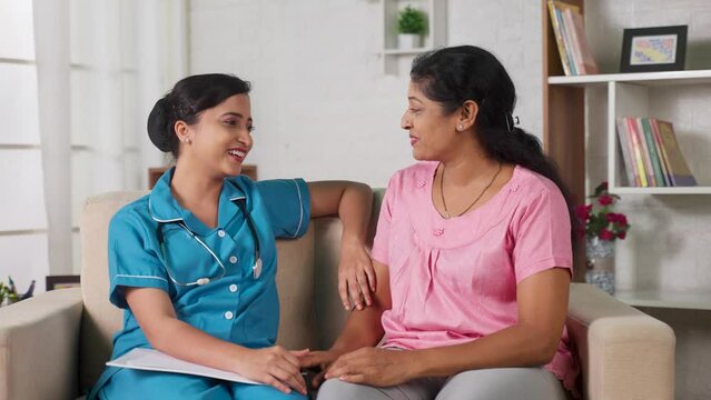 Happy Indian Nurse Talking With Recovered Women At Home - Smiling Daughter Spending Time With Mother After Work - Concept Of Family Time, Professional Occupation And Togetherness